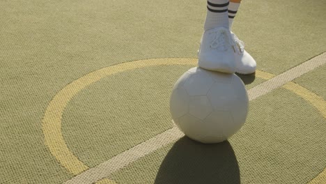 Close-Up-Of-Young-Woman-Placing-Football-On-Centre-Circle-Of-Artificial-Soccer-Pitch-In-Urban-City-For-Kick-Off-1