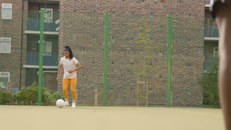 Players-Kicking-And-Passing-Football-On-Artificial-Soccer-Pitch-In-Urban-City-Area-3