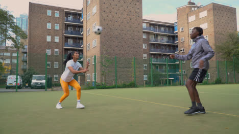 Players-Kicking-And-Passing-Football-On-Artificial-Soccer-Pitch-In-Urban-City-Area-7