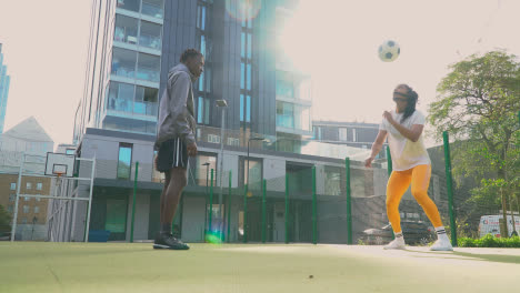 Players-Controlling-Football-On-Artificial-Soccer-Pitch-In-Urban-City-Area-4