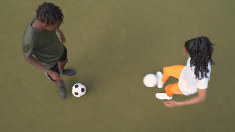 Overhead-Shot-Of-Male-And-Female-Soccer-Players-Practising-Passing-Football