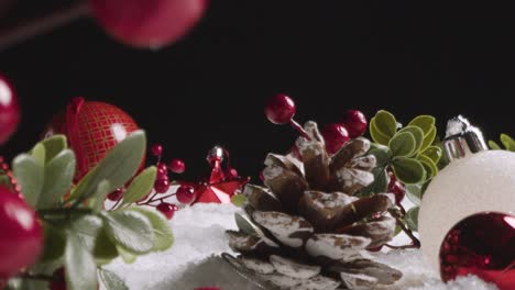 Studio-Christmas-Still-Life-With-Tree-Decorations-Berries-And-Pine-Cones-On-Artificial-Snow