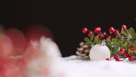 Studio-Christmas-Still-Life-With-Decorations-Berries-And-Pine-Cones-On-Artificial-Snow-5
