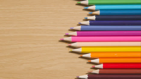 Coloured-Pencils-Geometrically-Arranged-In-A-Line-On-Wooden-Background-2