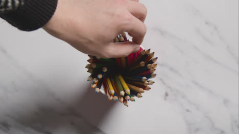 Overhead-Shot-Of-Multi-Coloured-Pencils-In-Pot-On-Marble-Background