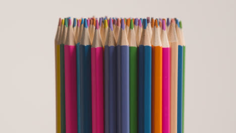 Studio-Shot-Of-Rotating-Multi-Coloured-Pencils-Against-White-Background-1