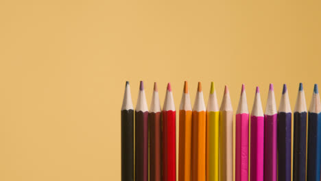 Studio-Shot-Of-Multi-Coloured-Pencils-Against-Yellow-Background-3