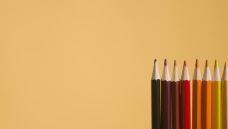 Studio-Shot-Of-Multi-Coloured-Pencils-Against-Yellow-Background-4
