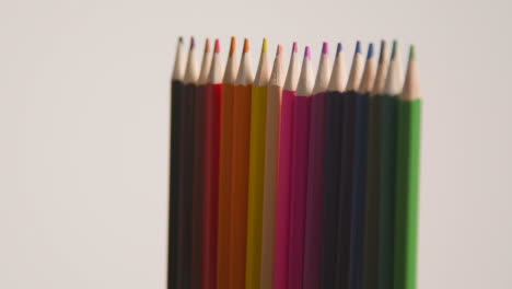 Studio-Shot-Of-Rotating-Line-Of-Multi-Coloured-Pencils-Against-White-Background-1