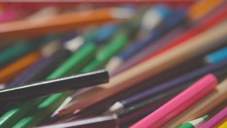 Full-Frame-Shot-Of-Multi-Coloured-Pencils-With-Hand-Reaching-In-To-Choose-Purple-One