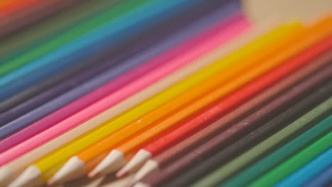 Studio-Shot-Of-Multi-Coloured-Pencils-In-A-Line-On-Wooden-Background-2