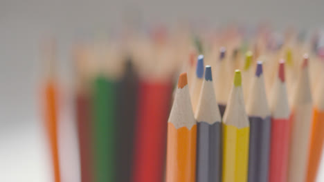 Close-Up-Of-Person-Picking-Up-Pink-Pencil-From-Pot-Of-Multi-Coloured-Pencils