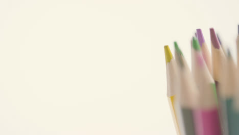 Studio-Shot-Of-Rotating-Multi-Coloured-Pencils-Against-White-Background-5