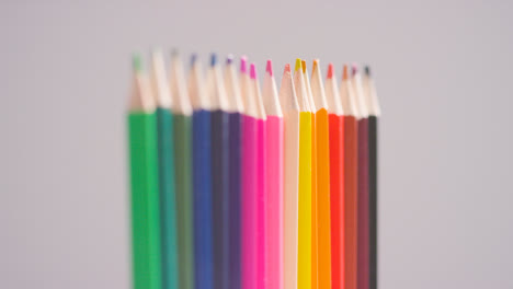 Studio-Shot-Of-Rotating-Line-Of-Multi-Coloured-Pencils-Against-White-Background-2
