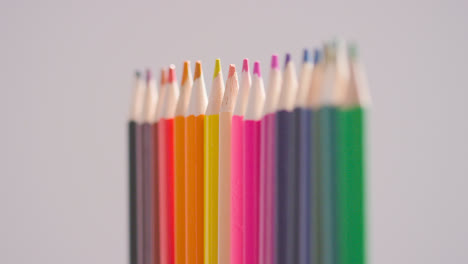 Studio-Shot-Of-Rotating-Line-Of-Multi-Coloured-Pencils-Against-White-Background-3