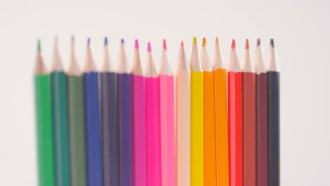 Studio-Shot-Of-Rotating-Line-Of-Multi-Coloured-Pencils-Against-White-Background-4