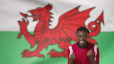 Young-Footballer-Celebrating-to-Camera-In-Front-of-Wales-Flag-01