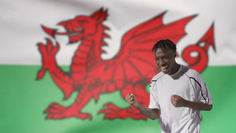 Young-Footballer-Celebrating-to-Camera-In-Front-of-Wales-Flag-02