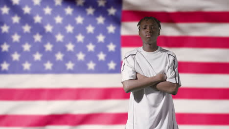 Young-Footballer-Walking-to-Camera-In-Front-of-USA-Flag-01