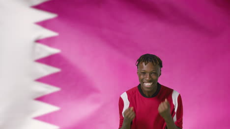 Young-Footballer-Celebrating-to-Camera-In-Front-of-Qatar-Flag-01