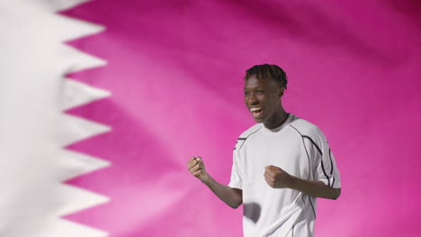 Young-Footballer-Celebrating-to-Camera-In-Front-of-Qatar-Flag-02