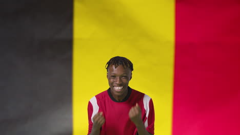 Young-Footballer-Celebrating-to-Camera-In-Front-of-Belgium-Flag-01