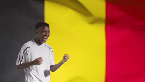 Young-Footballer-Celebrating-to-Camera-In-Front-of-Belgium-Flag-02