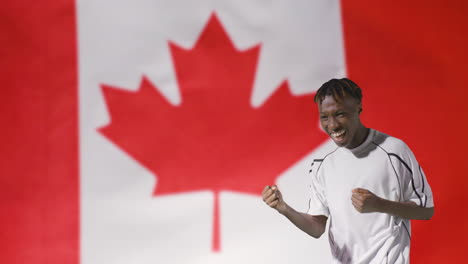 Young-Footballer-Celebrating-to-Camera-In-Front-of-Canada-Flag-02