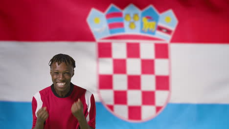 Young-Footballer-Celebrating-to-Camera-In-Front-of-Croatia-Flag-01