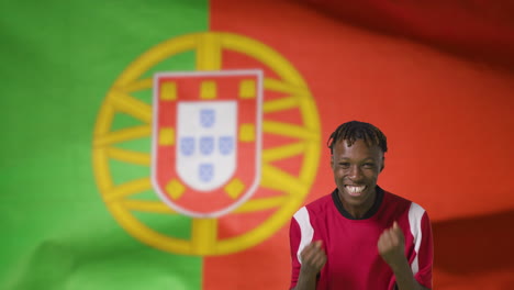 Young-Footballer-Celebrating-to-Camera-In-Front-of-Portugal-Flag-01