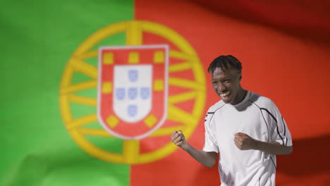 Young-Footballer-Celebrating-to-Camera-In-Front-of-Portugal-Flag-02