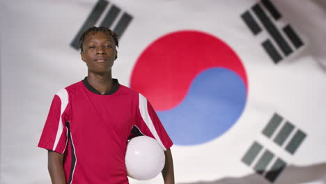 Young-Footballer-Posing-In-Front-of-South-Korea-Flag-01