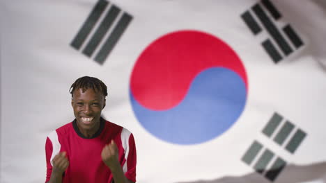 Young-Footballer-Celebrating-to-Camera-In-Front-of-South-Korea-Flag-01