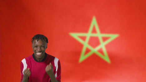 Young-Footballer-Celebrating-to-Camera-In-Front-of-Morocco-Flag-01