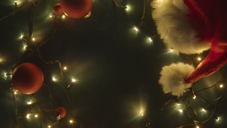 Overhead-Shot-Of-Holiday-Concept-Shot-With-Revolving-Christmas-Decorations-Lights-And-Santa-Hat-