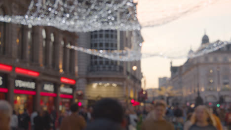 Defocused-Shot-Of-Lights-And-Christmas-Decorations-Outside-Shops-Near-Leicester-Square-In-London-UK