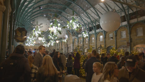Christmas-Lights-And-Decorations-With-Shoppers-In-Covent-Garden-London-UK-At-Night