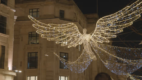 Close-Up-Of-Angel-Christmas-Light-Decoration-Across-Shops-On-London-UK-Regent-Street-At-Night-1