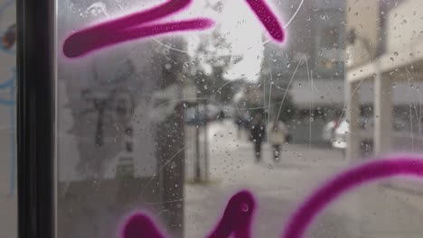 Shot-Through-Graffiti-Covered-Glass-In-Inner-City-Housing-Development-In-Tower-Hamlets-London-UK
