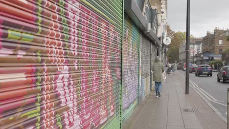 Closed-Shop-Shutters-Spray-Painted-With-Tags-And-Graffiti-in-Tower-Hamlets-London-In-UK-2