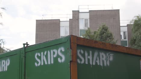 Waste-Skip-Outside-Inner-City-Housing-Development-In-Tower-Hamlets-London-UK-1