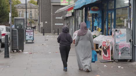 Shops-On-Street-Covered-With-Rubbish-In-Tower-Hamlets-London-UK-With-Customers-1
