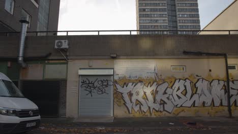 Graffiti-On-Walls-Outside-Inner-City-Housing-Development-In-Tower-Hamlets-London-UK-1