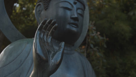 Nahaufnahme-Der-Skulptur-Von-Buddha-Im-Arboretum-Mit-Bunten-Herbstbäumen-Im-Hintergrund
