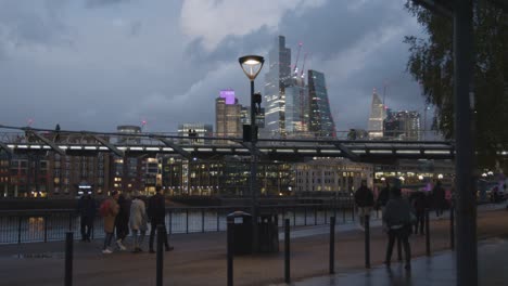 London-Evening-Skyline-From-South-Bank-With-River-Thames-Millennium-Bridge-And-City-At-Night