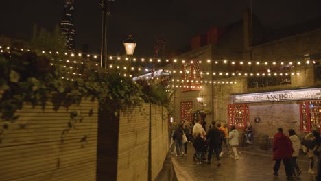 Christmas-Tree-Outside-Shops-And-Restaurants-On-London-South-Bank-At-Night-2