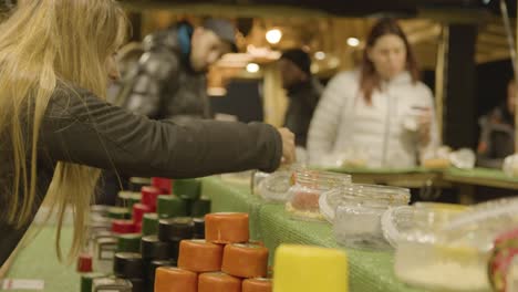 Close-Up-Customers-At-Stall-Selling-Cheese-At-Christmas-Market-On-London-South-Bank-At-Night