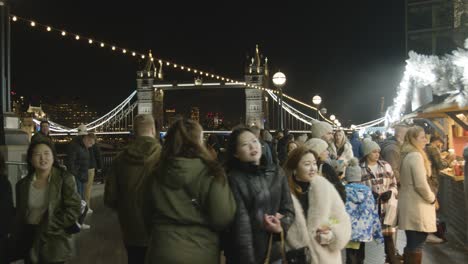 Busy-Christmas-Market-Stalls-Looking-Towards-Tower-Bridge-On-London-South-Bank-At-Night-3