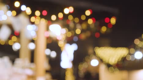 Defocused-Twinkling-Lights-On-Busy-Christmas-Market-Food-Stalls-In-Birmingham-UK-At-Night