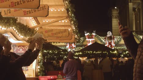 Food-And-Drink-Stalls-At-Frankfurt-Christmas-Market-In-Birmingham-UK-At-Night-3